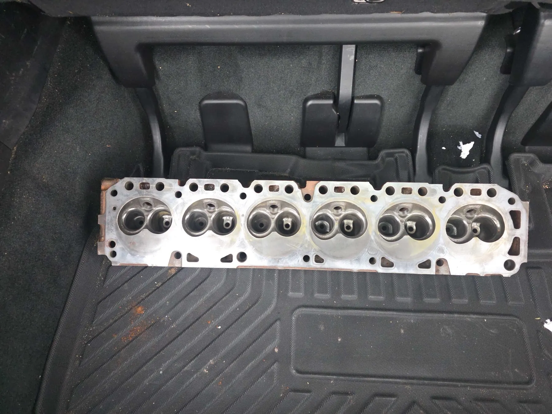 Cylinder head laid out during engine inspection at Rob's Automotive Repair Center in Clackamas, Oregon