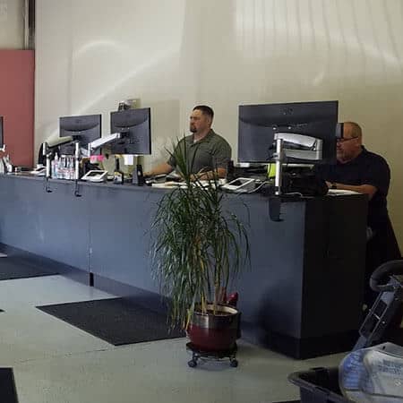 Service advisors at Rob's Automotive Repair Center in Clackamas, Oregon helping customers with financing options