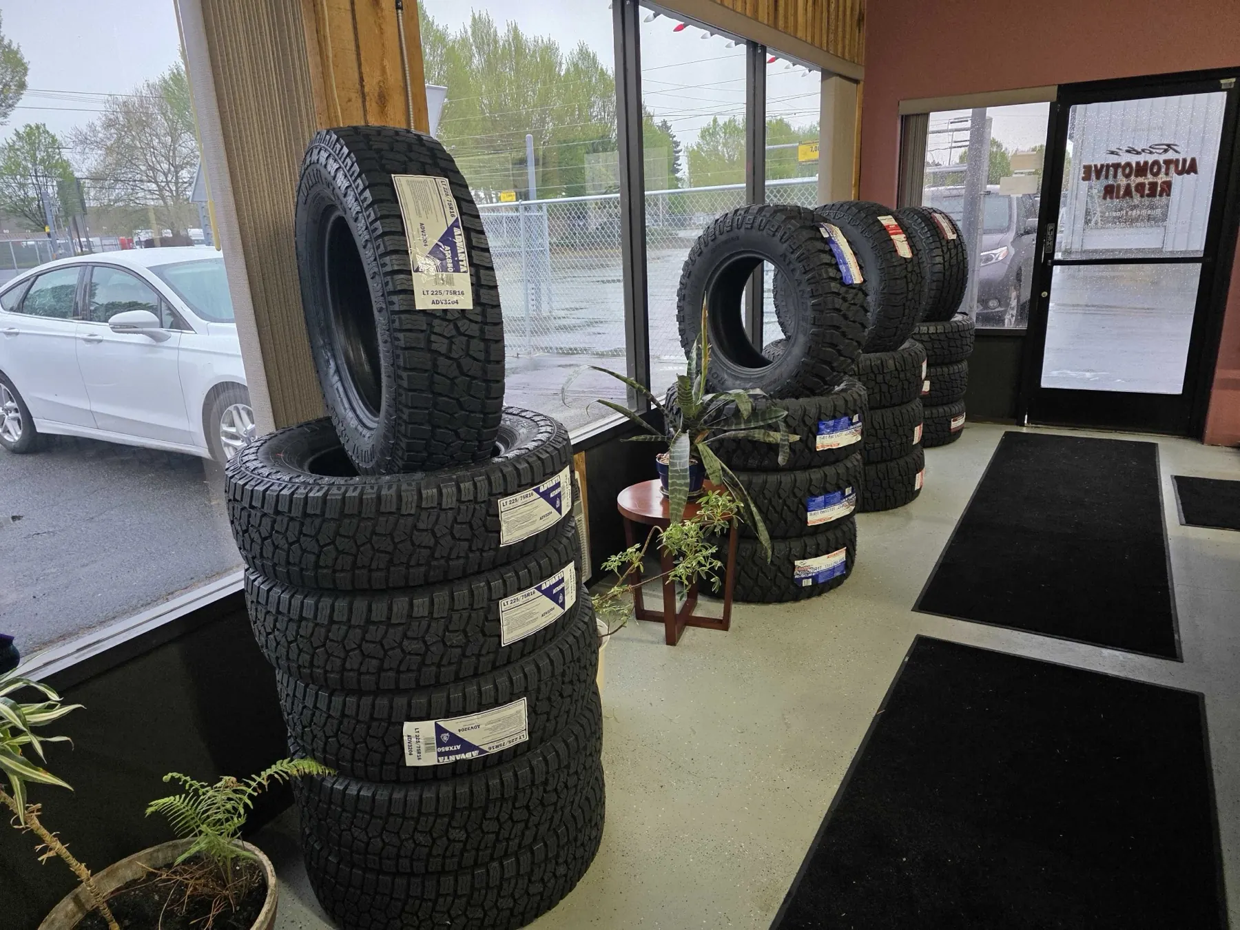 Customer waiting lobby at Rob's Automotive Repair Center in Clackamas, Oregon — stocked with all-terrain tires for trucks and SUVs