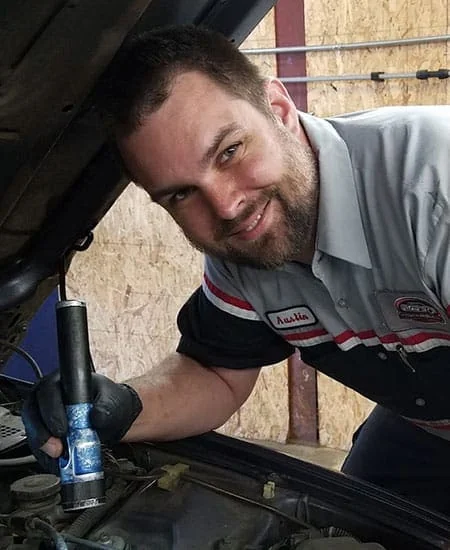 ASE-Certified technician inspecting the cooling system at Rob's Automotive Repair Center, Clackamas, OR