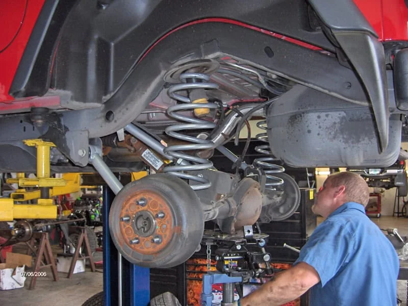 Technician performing an oil change at Rob's Automotive Repair Center, Clackamas, Oregon