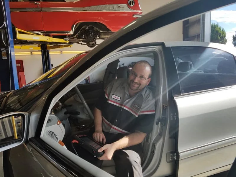 ASE-Certified technician running diagnostics at Rob's Automotive Repair Center, Clackamas, Oregon
